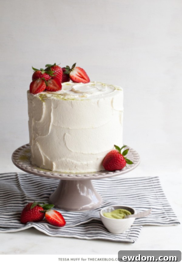 Strawberry Matcha Delight 7 A close-up of the assembled Matcha Strawberry Cake with a perfectly smooth frosting finish and fresh berries on top.