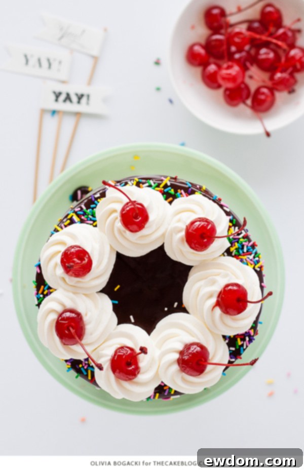 Ultimate Banana Split Cake 6 Assembling a Banana Split Layer Cake, showing the process of layering cake, buttercream, and fruit fillings | by Olivia Bogacki for TheCakeBlog.com