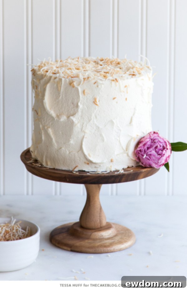 Tropical Coconut Tres Leches Cake 5 The finished Coconut Tres Leches Cake, decorated with whipped cream and abundant toasted coconut flakes, ready to be served, by Tessa Huff