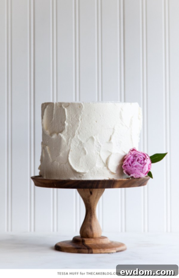 Tropical Coconut Tres Leches Cake 8 Another perspective of the assembled Coconut Tres Leches Layer Cake, showcasing its height and elegant decoration, by Tessa Huff