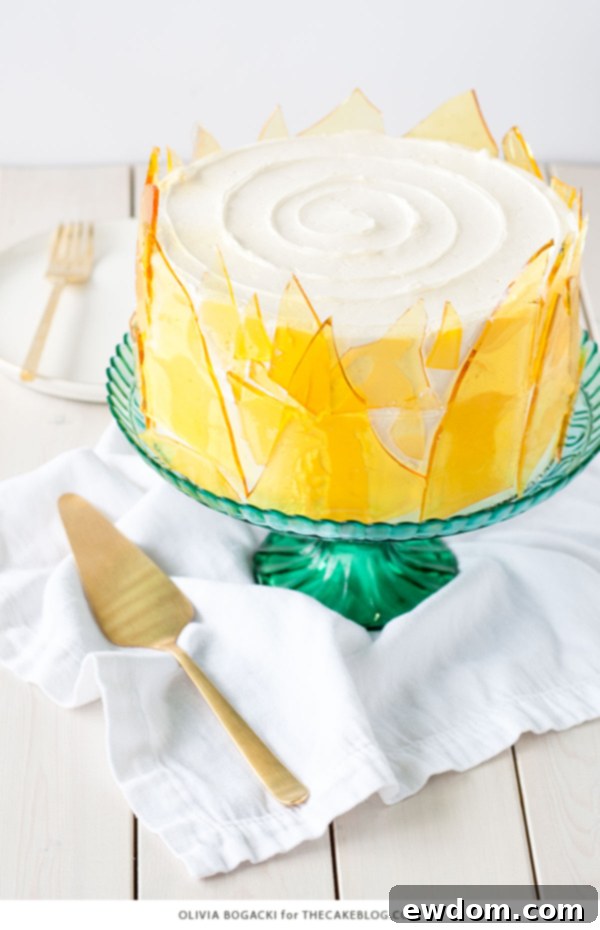 Caramelized Custard Dream Cake 3 Close-up of a slice of Crème Brûlée Cake, showing layers of vanilla cake, custard, buttercream, and caramel crunch. Created by Olivia Bogacki for TheCakeBlog.com