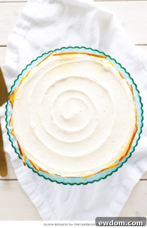 Caramelized Custard Dream Cake 7 A stunning Crème Brûlée Layer Cake adorned with sharp, glistening caramel sugar shards, embodying a sophisticated dessert experience from Olivia Bogacki.