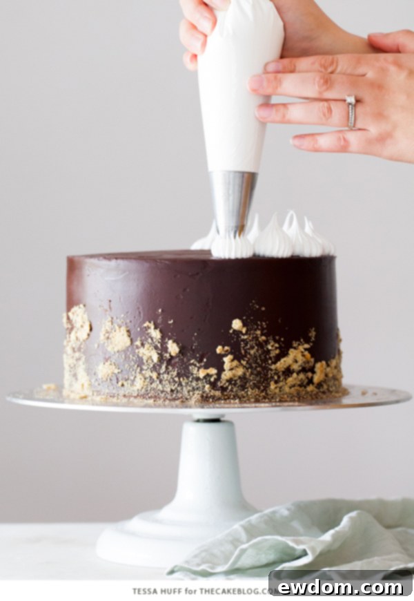 S'mores Cake - s'more inspired layer cake recipe with chocolate cake, graham cracker buttercream, chocolate ganache and toasted marshmallow meringue | by Tessa Huff for TheCakeBlog.com