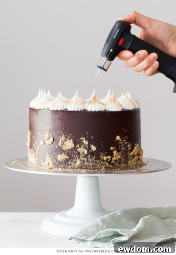 S'mores Cake - s'more inspired layer cake recipe with chocolate cake, graham cracker buttercream, chocolate ganache and toasted marshmallow meringue | by Tessa Huff for TheCakeBlog.com