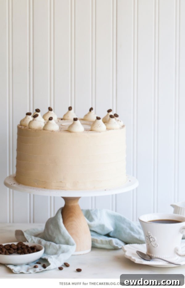 Caramel Cappuccino Cake - espresso cake paired with caramel buttercream frosting, topped with whole coffee beans and a sprinkle of cocoa powder | by Tessa Huff for TheCakeBlog.com