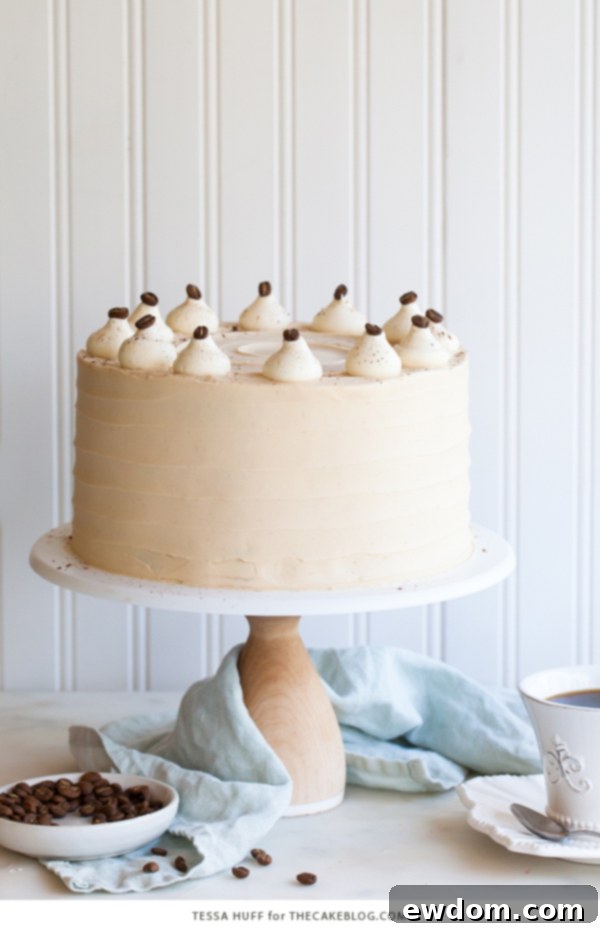 Caramel Cappuccino Cake - espresso cake paired with caramel buttercream frosting, topped with whole coffee beans and a sprinkle of cocoa powder | by Tessa Huff for TheCakeBlog.com