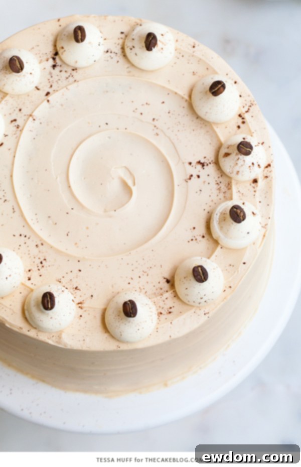 Caramel Cappuccino Cake - espresso cake paired with caramel buttercream frosting, topped with whole coffee beans and a sprinkle of cocoa powder | by Tessa Huff for TheCakeBlog.com