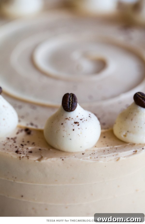 Caramel Cappuccino Cake - espresso cake paired with caramel buttercream frosting, topped with whole coffee beans and a sprinkle of cocoa powder | by Tessa Huff for TheCakeBlog.com