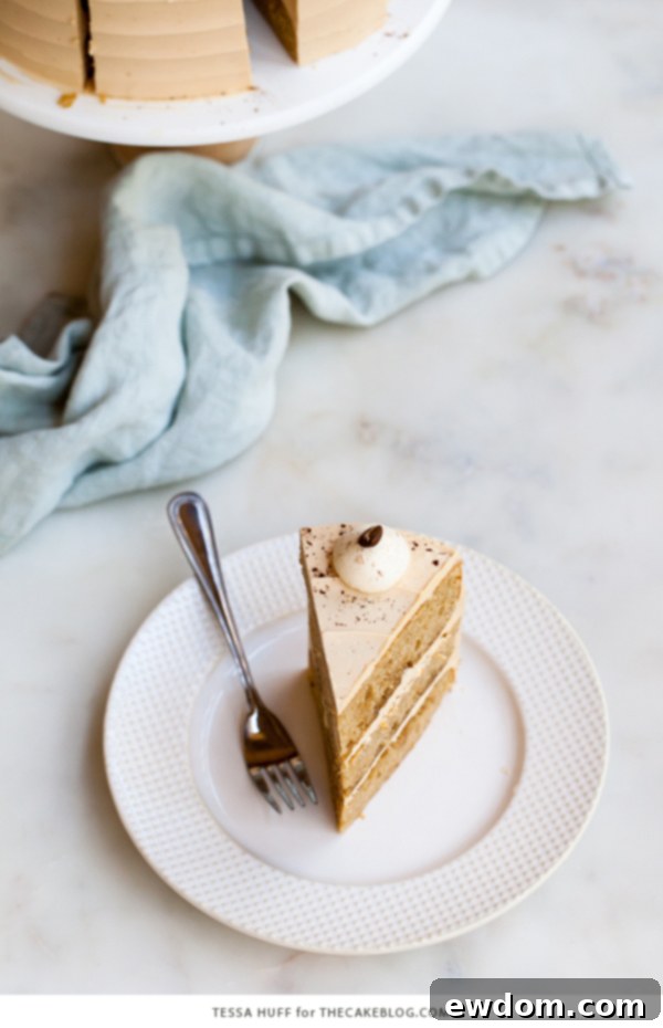 Caramel Cappuccino Cake - espresso cake paired with caramel buttercream frosting, topped with whole coffee beans and a sprinkle of cocoa powder | by Tessa Huff for TheCakeBlog.com