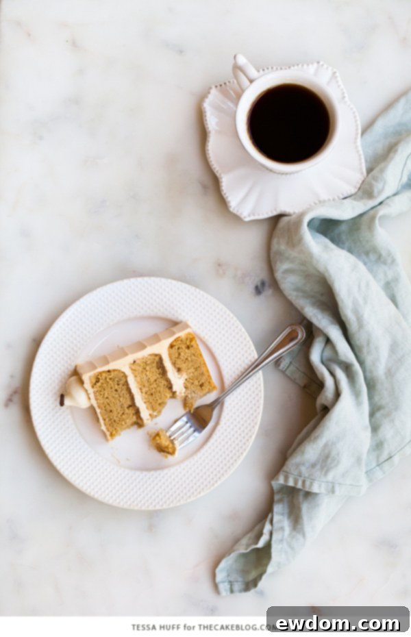 Caramel Cappuccino Cake - espresso cake paired with caramel buttercream frosting, topped with whole coffee beans and a sprinkle of cocoa powder | by Tessa Huff for TheCakeBlog.com