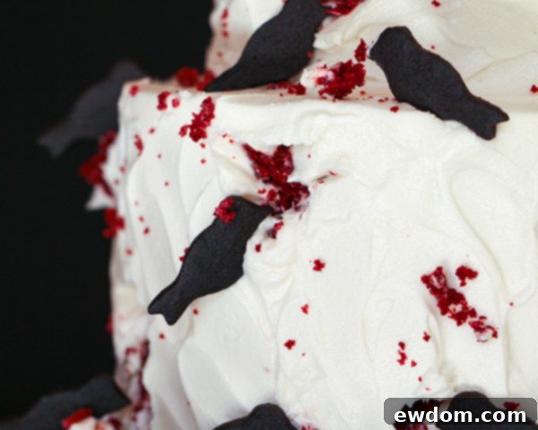 Scattering cake crumbs around the bird cookies for a realistic 'pecked' effect