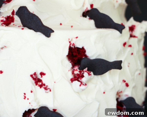 Completed Black Crow Halloween cake with multiple bird cookies and scattered crumbs