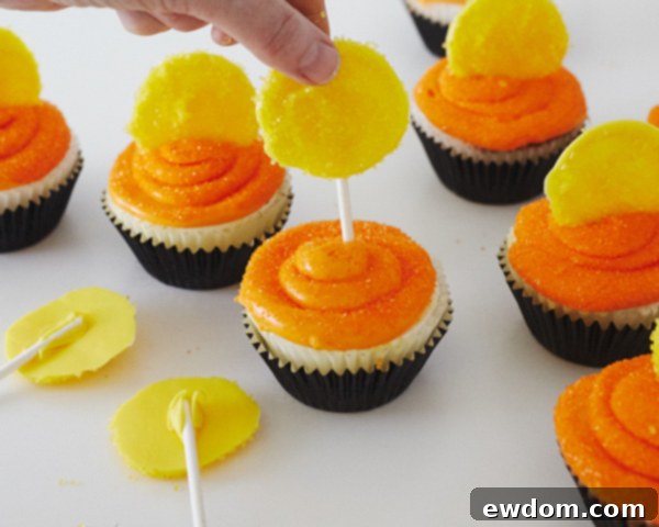 Inserting a Candy Moon with Sucker Stick into a Frosted Cupcake