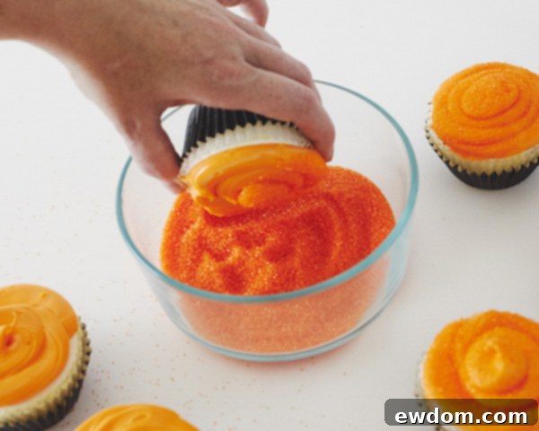 Coating Orange Frosted Cupcakes with Orange Sanding Sugar