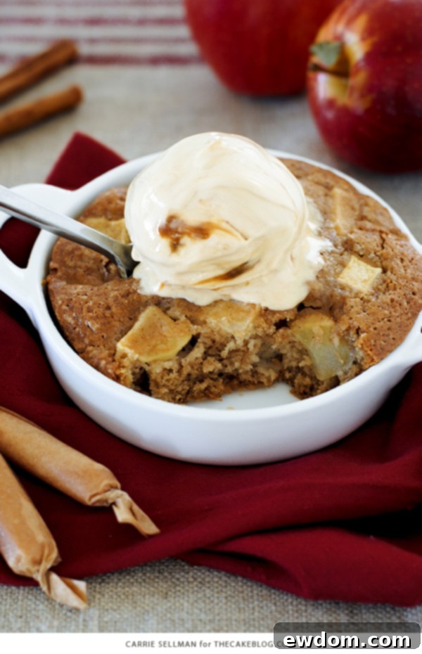 Close-up of spoon digging into apple cake and gelato dessert