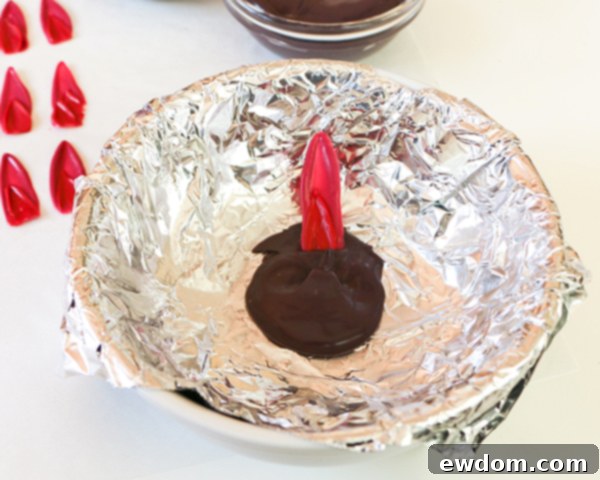 Attaching the first layer of two-toned chocolate petals to the black chocolate base