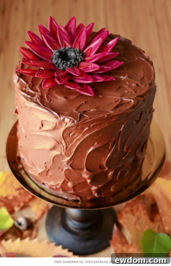 Giant chocolate sunflower cake in vibrant jewel tones on a buttercream cake