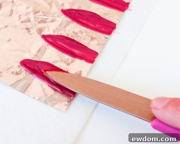 Two-toned chocolate petals hardening on aluminum foil, ready for assembly
