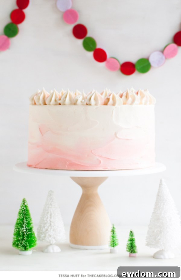 Stunning slice of Peppermint Red Velvet Cake showcasing vibrant red layers and creamy white chocolate peppermint buttercream