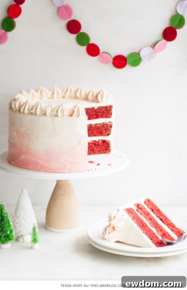 Close-up of the Peppermint Red Velvet Cake's side, showing distinct cake layers and creamy peppermint buttercream