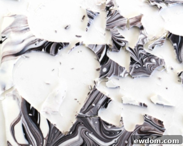 A close-up of a perfectly cut marbled chocolate heart, highlighting the unique pattern and smooth edges achieved through the cutting process.
