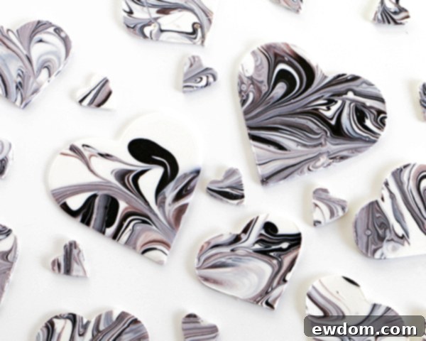 An array of various sized marbled chocolate hearts, showcasing the beautiful diversity of patterns and potential for different design applications.