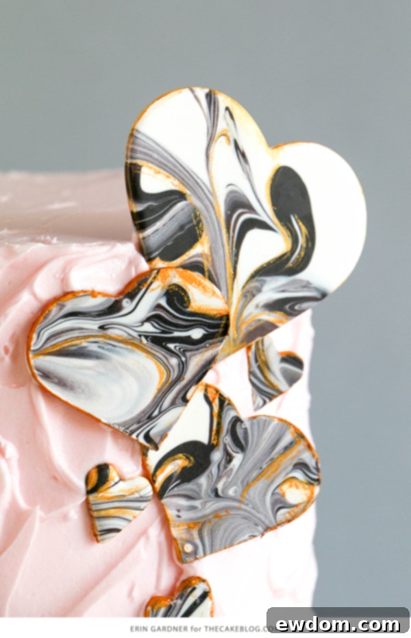 Close-up of a marbled chocolate heart with delicate gold painted lines, demonstrating the intricate details achievable with this DIY tutorial.