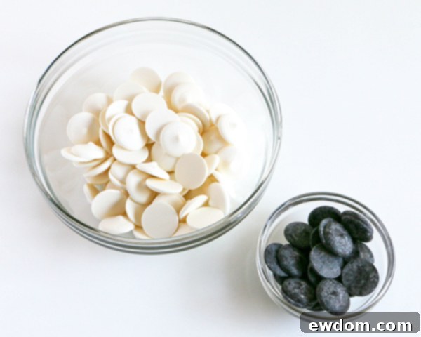 Separate bowls of melted white and black coating chocolate, ready for the marbling process, demonstrating the initial setup.