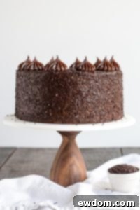 Chocolate Truffle Cake - a chocolate layer cake recipe with dense, moist chocolate cake, silky chocolate truffle frosting and chocolate flakes | by Olivia Bogacki for TheCakeBlog.com