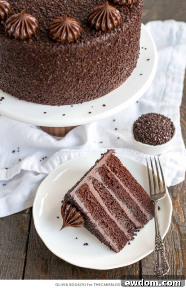 Chocolate Truffle Cake - a chocolate layer cake recipe with dense, moist chocolate cake, silky chocolate truffle frosting and chocolate flakes | by Olivia Bogacki for TheCakeBlog.com