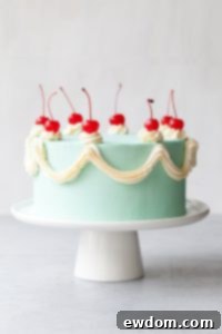 Cherry Chip Cake - maraschino cherry cake studded with chocolate chips, layered with chocolate ganache and finished with a whipped vanilla buttercream frosting | by Tessa Huff for TheCakeBlog.com
