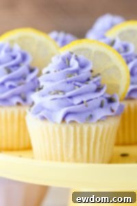 Lemon Lavender Cupcakes with light lavender frosting and fresh lemon slices.