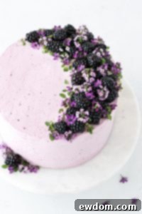 Blackberry Lime Cake - tender cake infused with lime zest, frosted with blackberry buttercream, topped with fresh blackberries and edible flowers | by Carrie Sellman for TheCakeBlog.com
