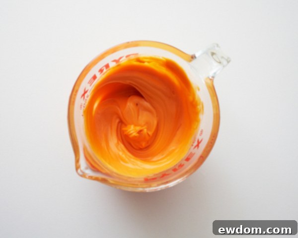 Melting orange and green candy coating for garden cupcake decorations