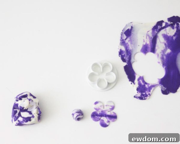 Rolling fondant and cutting a five-petal flower shape for cabbage leaves