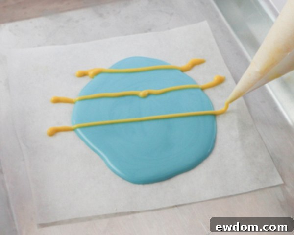 Elegant Swirl Easter Chocolates 12 Piping contrasting lines of colorful chocolate over a base layer to prepare for the marbling effect.