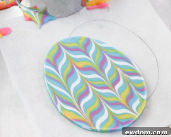 Elegant Swirl Easter Chocolates 18 A freshly cut marbled chocolate egg being lifted from the parchment paper, showcasing its perfect shape and vibrant design.