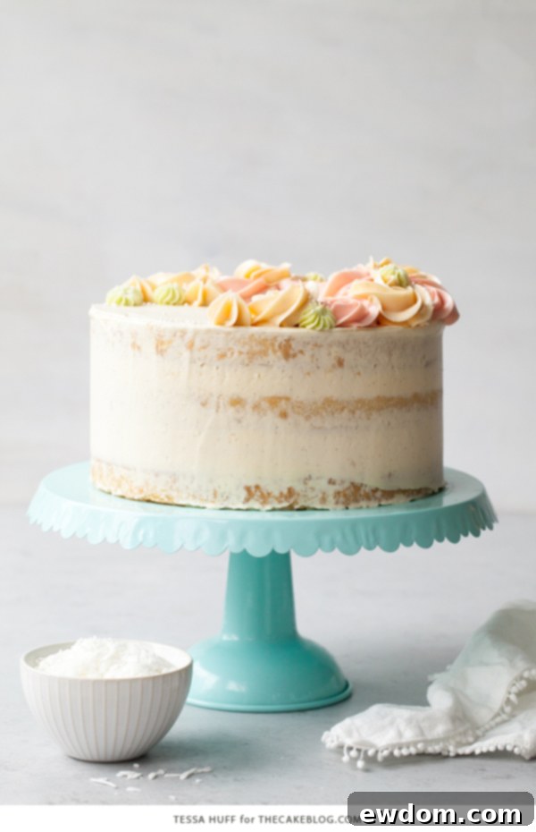 Coconut Cake - homemade coconut cake with creamy coconut milk, brushed with coconut syrup to keep it extra moist, and topped with vanilla bean buttercream frosting | by Tessa Huff for TheCakeBlog.com