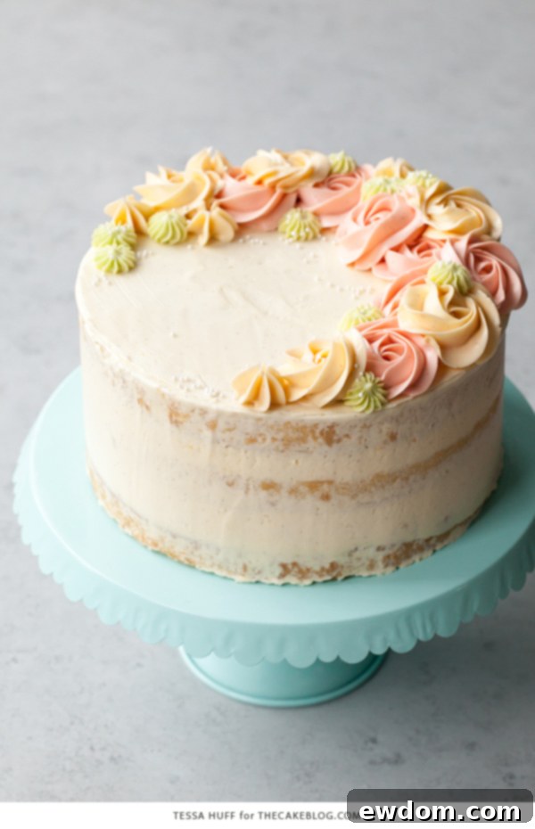 Coconut Cake - homemade coconut cake with creamy coconut milk, brushed with coconut syrup to keep it extra moist, and topped with vanilla bean buttercream frosting | by Tessa Huff for TheCakeBlog.com