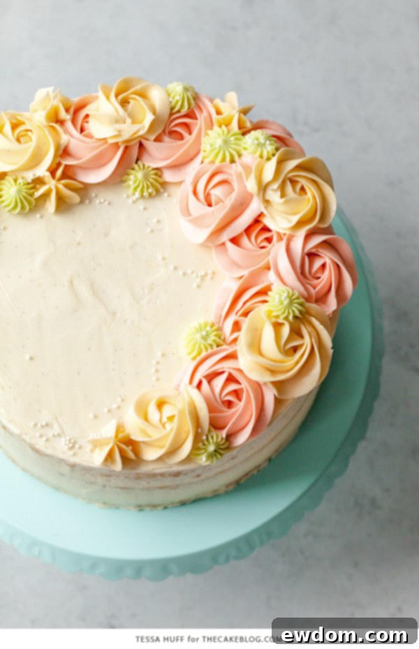 Coconut Cake - homemade coconut cake with creamy coconut milk, brushed with coconut syrup to keep it extra moist, and topped with vanilla bean buttercream frosting | by Tessa Huff for TheCakeBlog.com