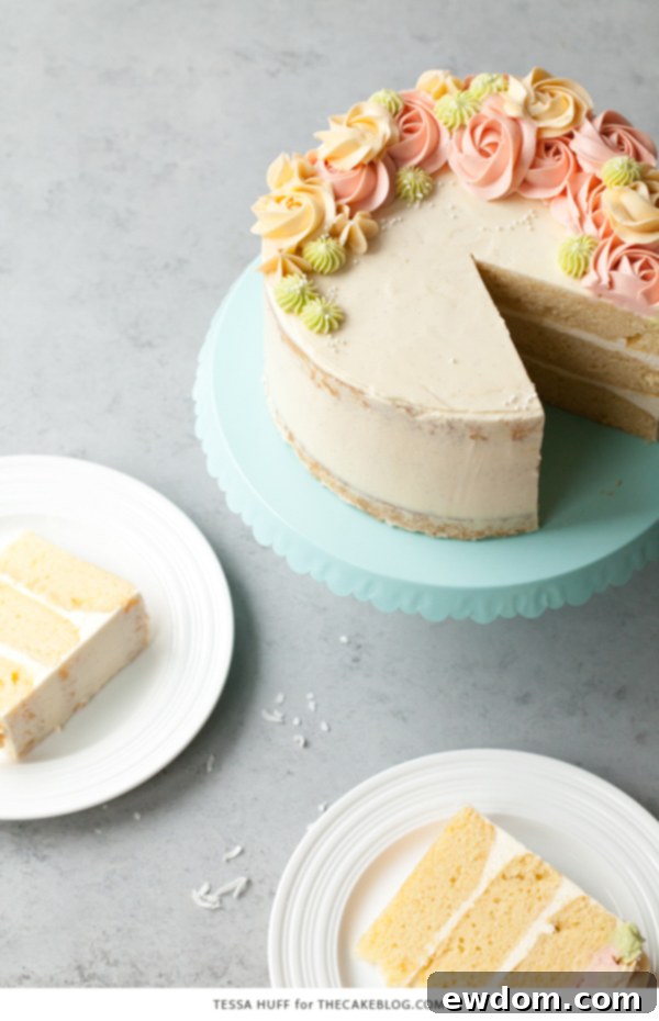 Coconut Cake - homemade coconut cake with creamy coconut milk, brushed with coconut syrup to keep it extra moist, and topped with vanilla bean buttercream frosting | by Tessa Huff for TheCakeBlog.com