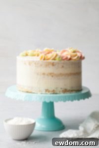 Coconut Cake - homemade coconut cake with creamy coconut milk, brushed with coconut syrup to keep it extra moist, and topped with vanilla bean buttercream frosting | by Tessa Huff for TheCakeBlog.com