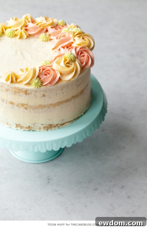 Coconut Cake - homemade coconut cake with creamy coconut milk, brushed with coconut syrup to keep it extra moist, and topped with vanilla bean buttercream frosting | by Tessa Huff for TheCakeBlog.com