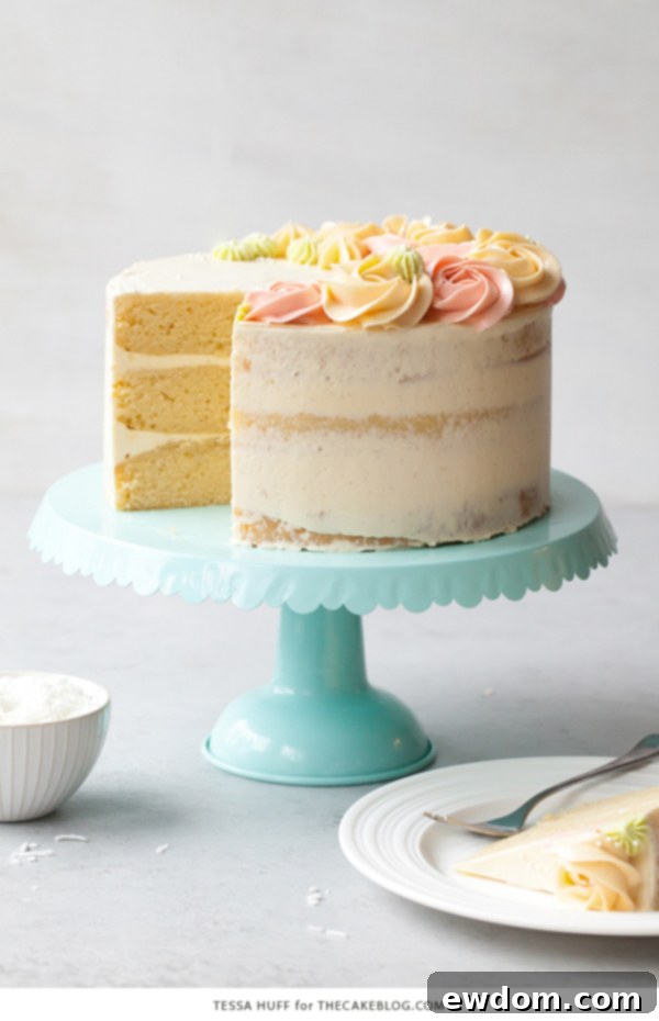 Coconut Cake - homemade coconut cake with creamy coconut milk, brushed with coconut syrup to keep it extra moist, and topped with vanilla bean buttercream frosting | by Tessa Huff for TheCakeBlog.com