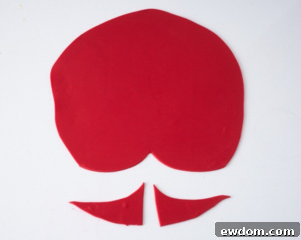 Matryoshka Magic Cake 11 Rolling out and draping red fondant for the Russian nesting doll cake's headscarf, showing the scalloped edge. Cake by Cakegirls.