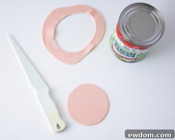 Matryoshka Magic Cake 15 Preparing the doll's face: tinting fondant to a flesh color and cutting a 4-inch circle. Cake by Cakegirls.