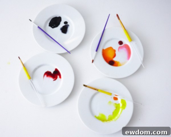 Matryoshka Magic Cake 18 Watercolor painting technique for the Russian nesting doll cake: mixing gel colors with alcohol and applying to fondant appliques and face. Cake by Cakegirls.