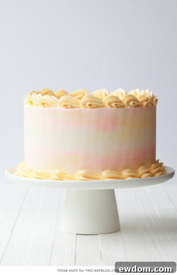 Stunning Lemon Honey Apricot Cake with pastel buttercream and fresh fruit garnish by Tessa Huff
