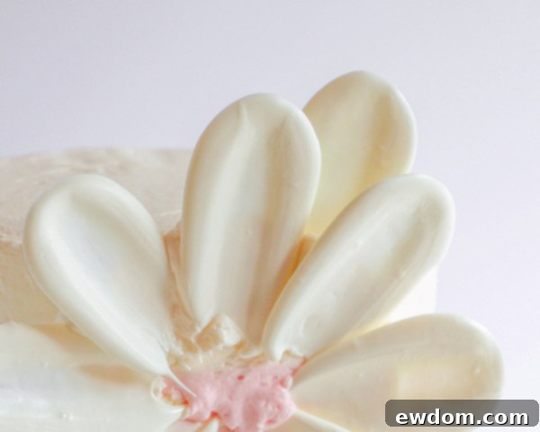 An outer row of white chocolate petals is added to the flower, carefully slid in behind the first row to create depth.