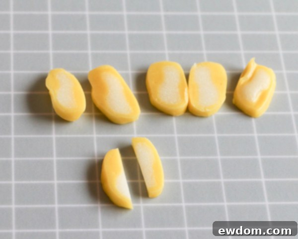 The sliced yellow taffy pieces are further cut in half lengthwise, creating smaller, more defined elements for the flower stamen.